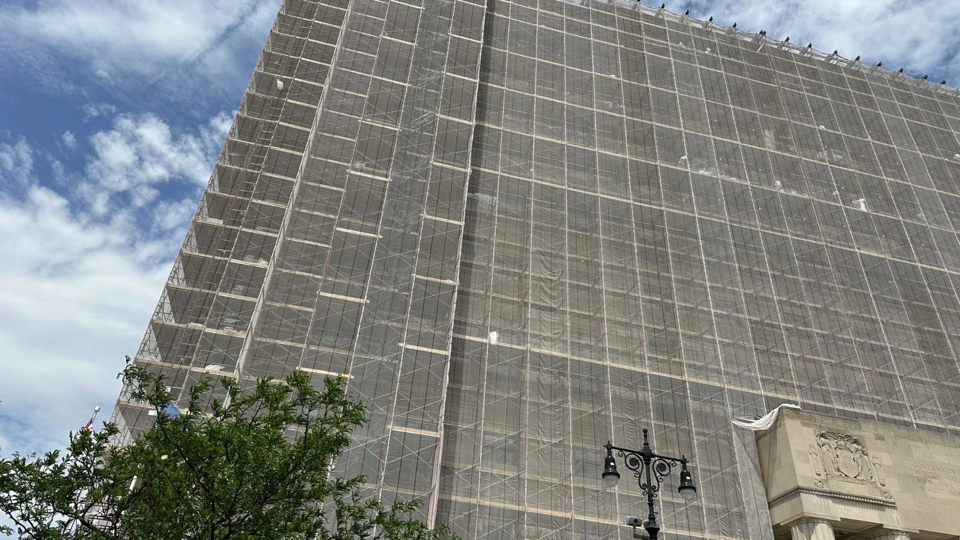 Sidewalk shed and scaffolding covering building entrance in NYC