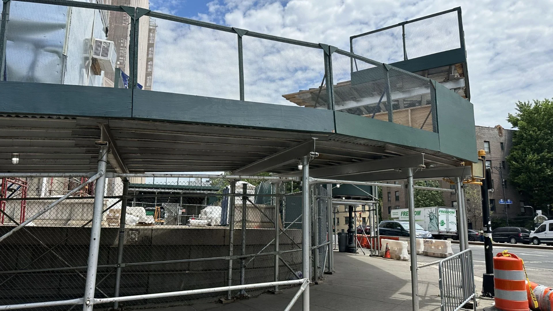 Sidewalk shed frame installed outside NYC residential building
